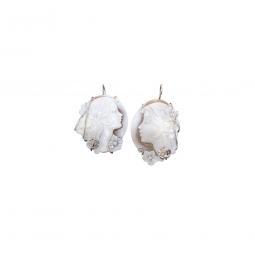 Earrings set in silver with woman face carving 
