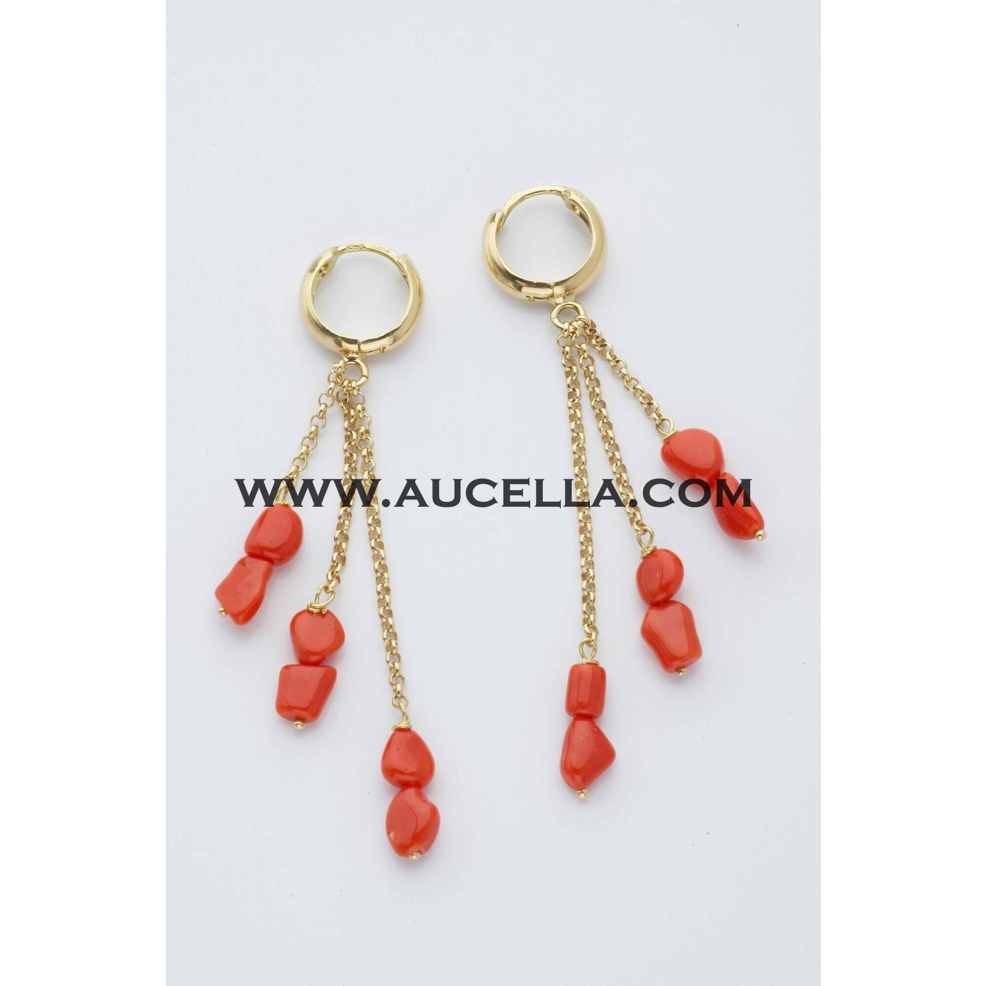 Earrings set in gold with small coral nuggets 