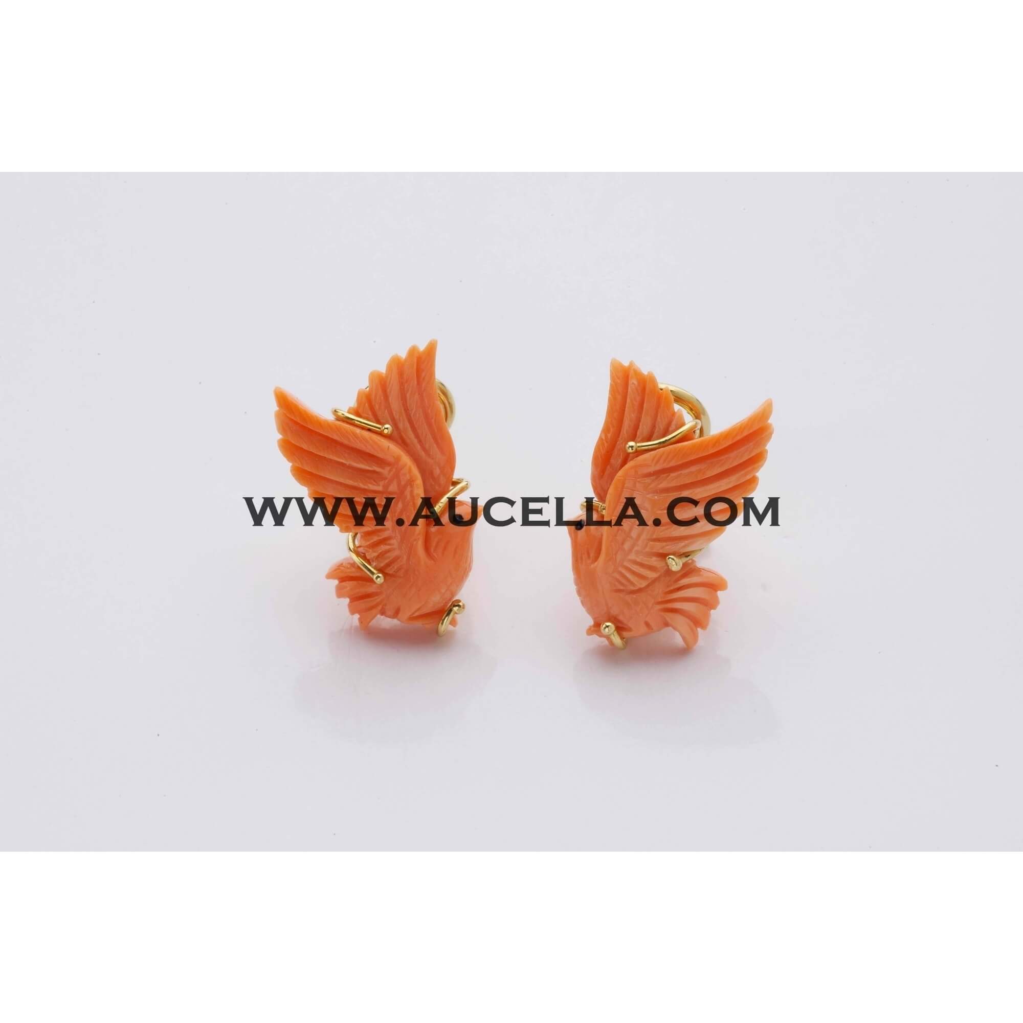 Earrings set in gold with handmade coral carving