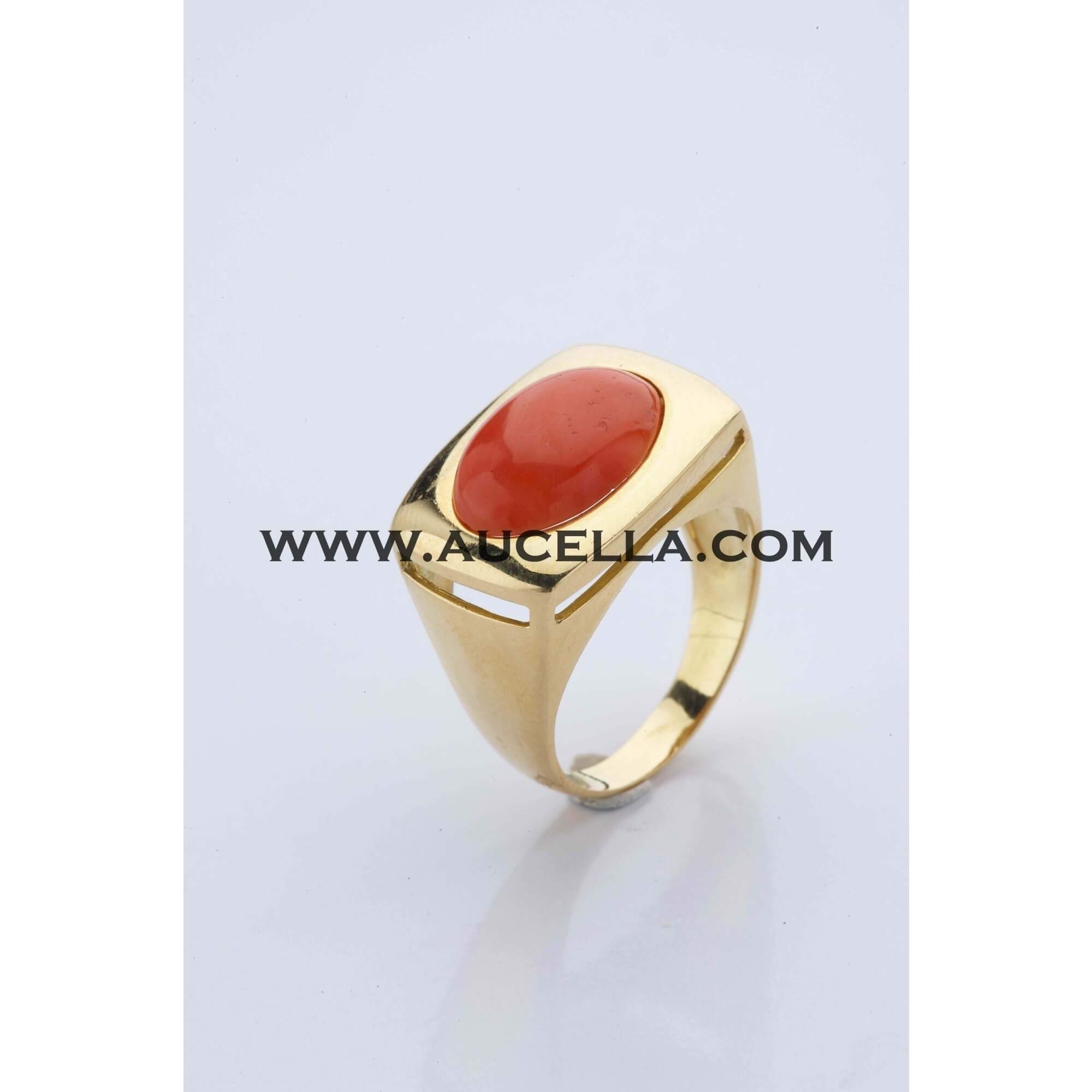 Gold ring set with oval coral cabochon 