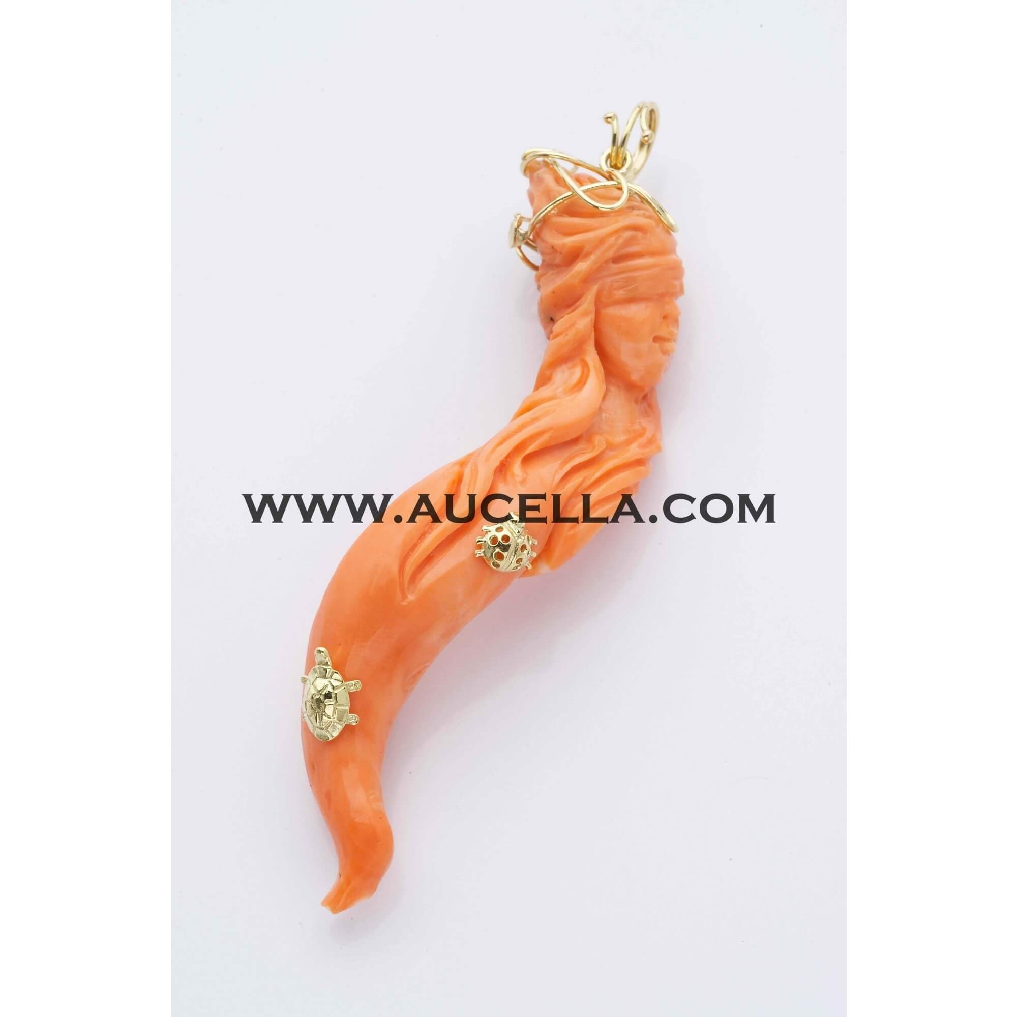 Pendant set in gold with coral carving lady luck