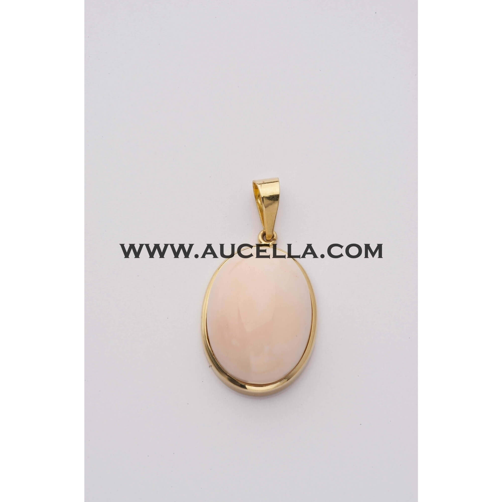 Pendant set in gold with pink coral cabochon